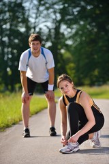 Couple doing stretching exercise  after jogging