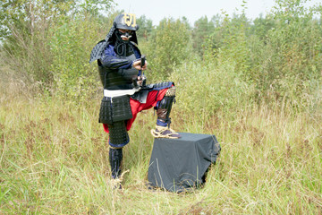 Samurai, wrapped in varaji, pulls his sword