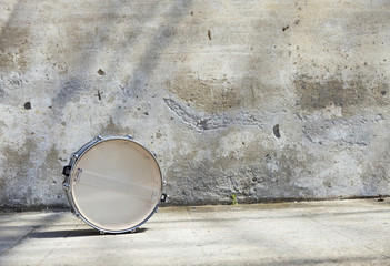 drum in front of a wall
