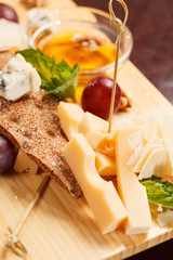 Cheese plate with grapes and honey