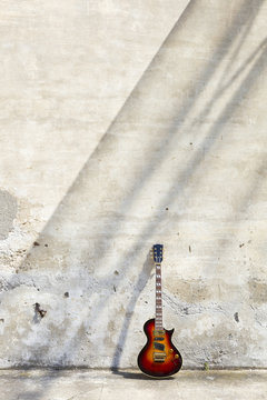 electric guitar in front of a vintage wall