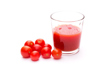 Glass of fresh tomato juice and some ripe tomatoes