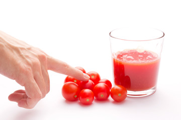 Hand choosing carefully a ripe tomato for broth