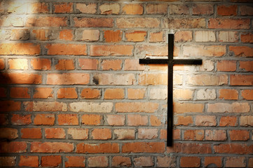 Cross and grunge wall on cemetery abstract background