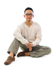 Asian man sitting on floor