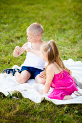 Fototapeta premium Little boy and girl with ladybird in park
