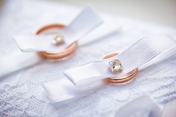 gold wedding rings on the pincushion