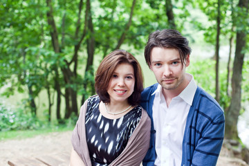 Fototapeta premium Young couple in love in summer forest