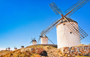 Famous windmills in Consuegra at sunset, Andalusia, Spain - obrazy, fototapety, plakaty