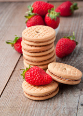 cookies with jam and strawberries on old wooden background 