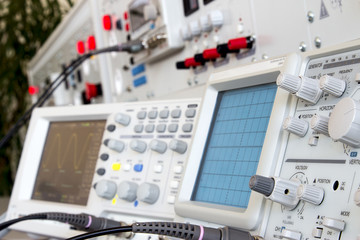analog and digital oscilloscope in the foreground