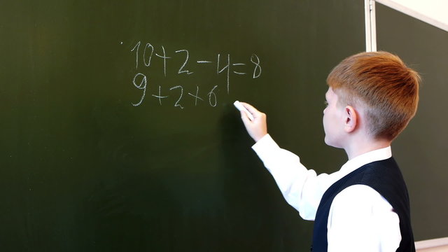 Serious schoolboy accounting equation during mathematic exam