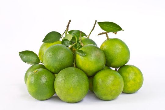 Stack of green sweet oranges on white background
