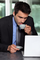 Man with computer and coffee cup