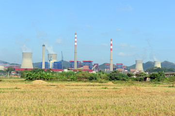 Fototapeta na wymiar Industrial landscape with chimneys tank
