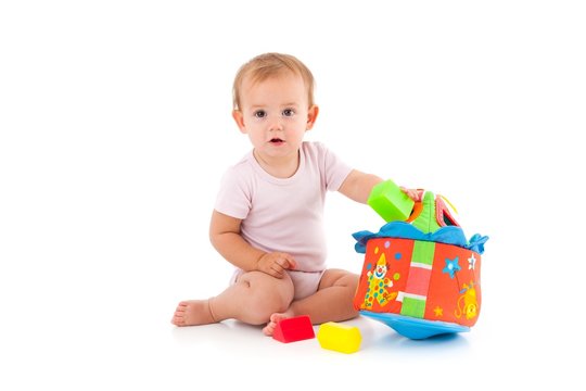 Lovely baby girl playing with toys