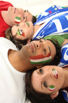 Four Italian soccer fans laying on the floor