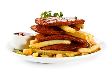Grilled steaks, French fries and vegetables