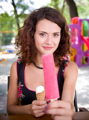 Beautiful woman holding pink ice cream