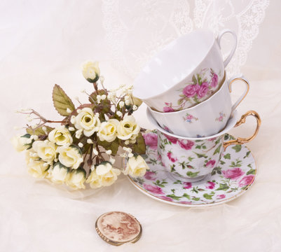 Vintage elegant cups with cameo and flowers