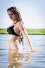 Obraz premium beautiful young girl swimming in a lake