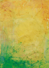 Paper with yellow, green, and brown paint abstract