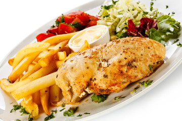 Grilled chicken breast, French fries and vegetables