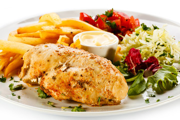 Grilled chicken breast, French fries and vegetables