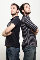 Two Confident Twins with Arms Folded