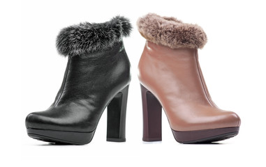 Two female ankle-high boots isolated over white