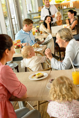 Mother and grandmother with children at cafe