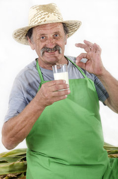 Organic Farmer Is Holding A Glass Of Milk