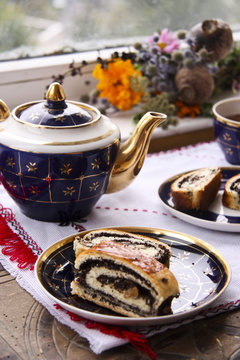 Tea and roll with poppy seeds