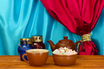Teapot with cup and saucer with  sweet turkish delight