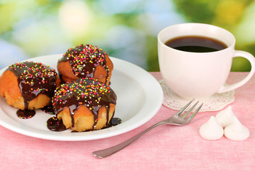 Appetizing cupcakes with chocolate on nature background