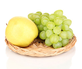 ripe sweet grapes and apple on wicker mat isolated on white