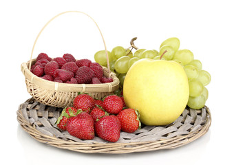 ripe sweet fruits and berries on wicker mat isolated on white
