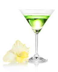 glass with cocktail and gladiolus bud isolated on white