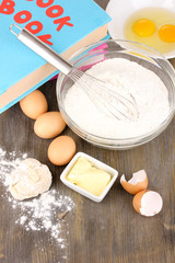 Eggs, flour and butter close-up on wooden table