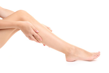 woman holding sore leg, isolated on white