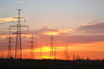 Electric power transmission lines at sunset