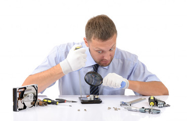 Man wearing gloves repairs hard drive on white background