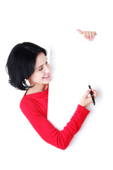 Naklejka premium Happy beautiful woman writing with a pen on blank board.