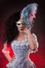 Beautiful Halloween vampire woman aristocrat with venetian mask
