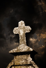 tombstone cross and dark sky