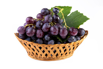 fresh grapes with leaf in basket isolated on white