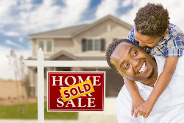 Mixed Race Father and Son In Front of Real Estate Sign and House