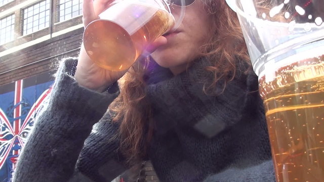 Beautiful young woman drinking beer