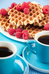 Waffles with raspberries and espresso coffee, vertical shot