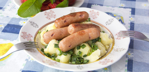 Grilled sausages and potatoes with herbs